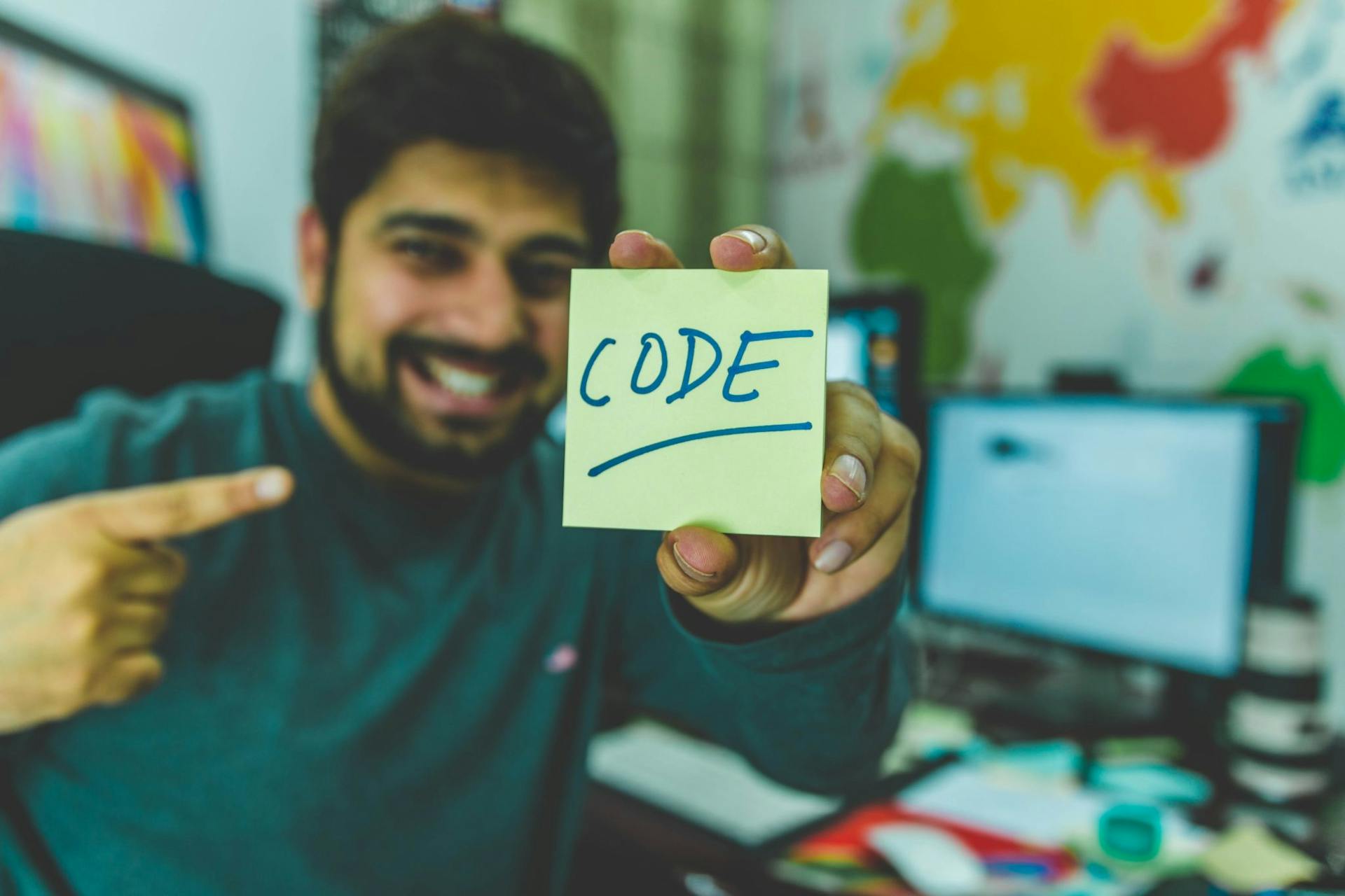 man with sticky note that says code